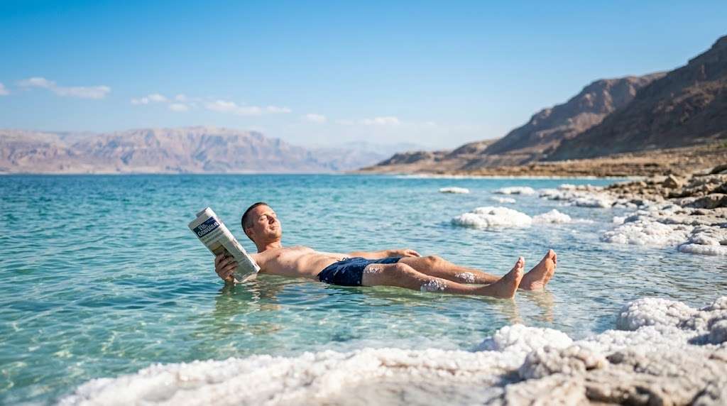 Things to Do in Israel Tourist floating in the Dead Sea Israel under a clear blue sky