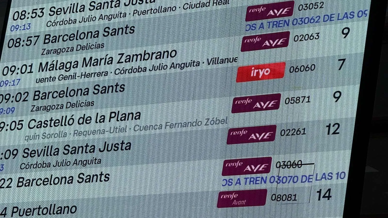 Departures board at Madrid Atocha showing AVE and iryo services: how to buy train tickets in Spain